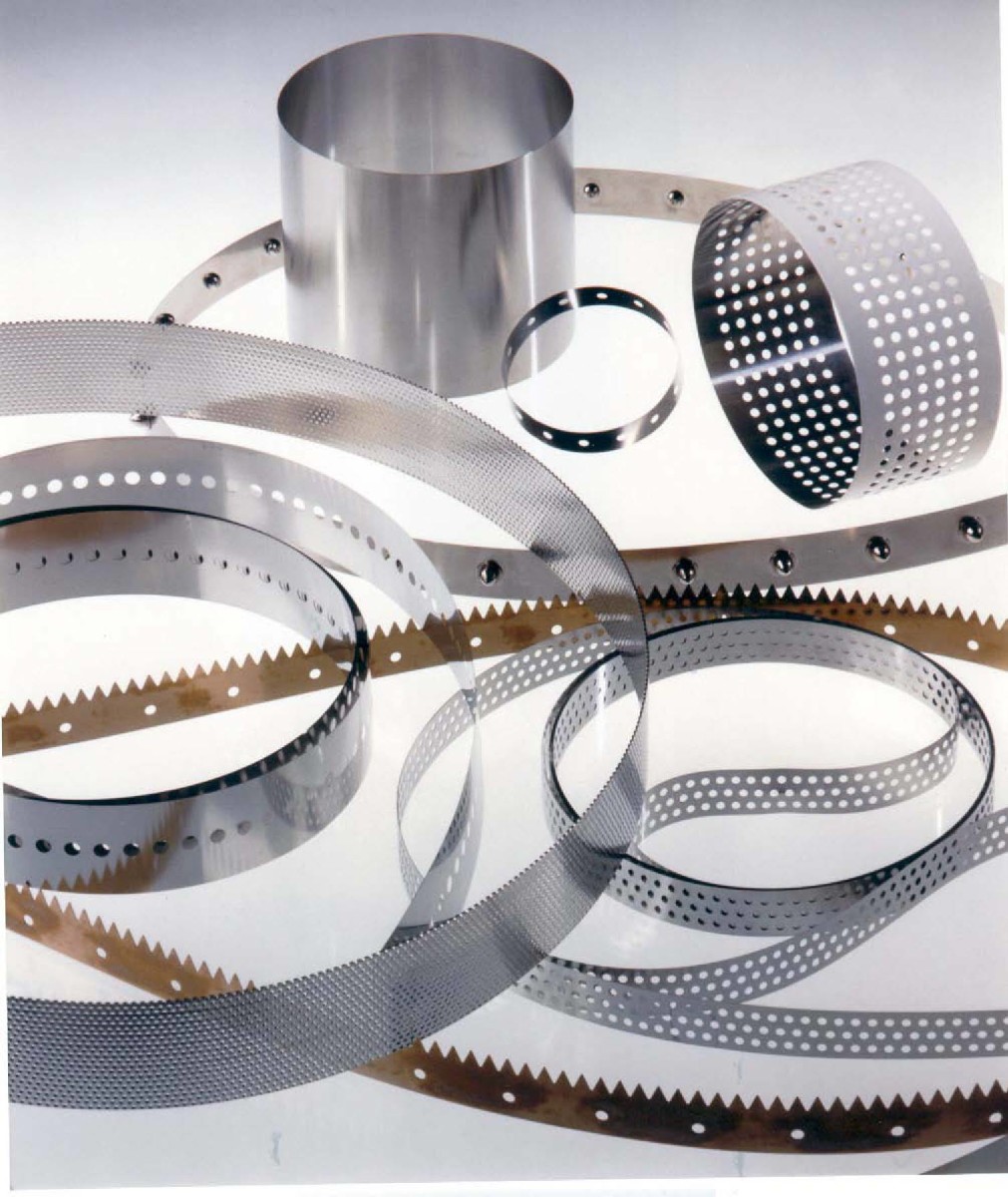 A wide selection of perforated metal belts on a table
