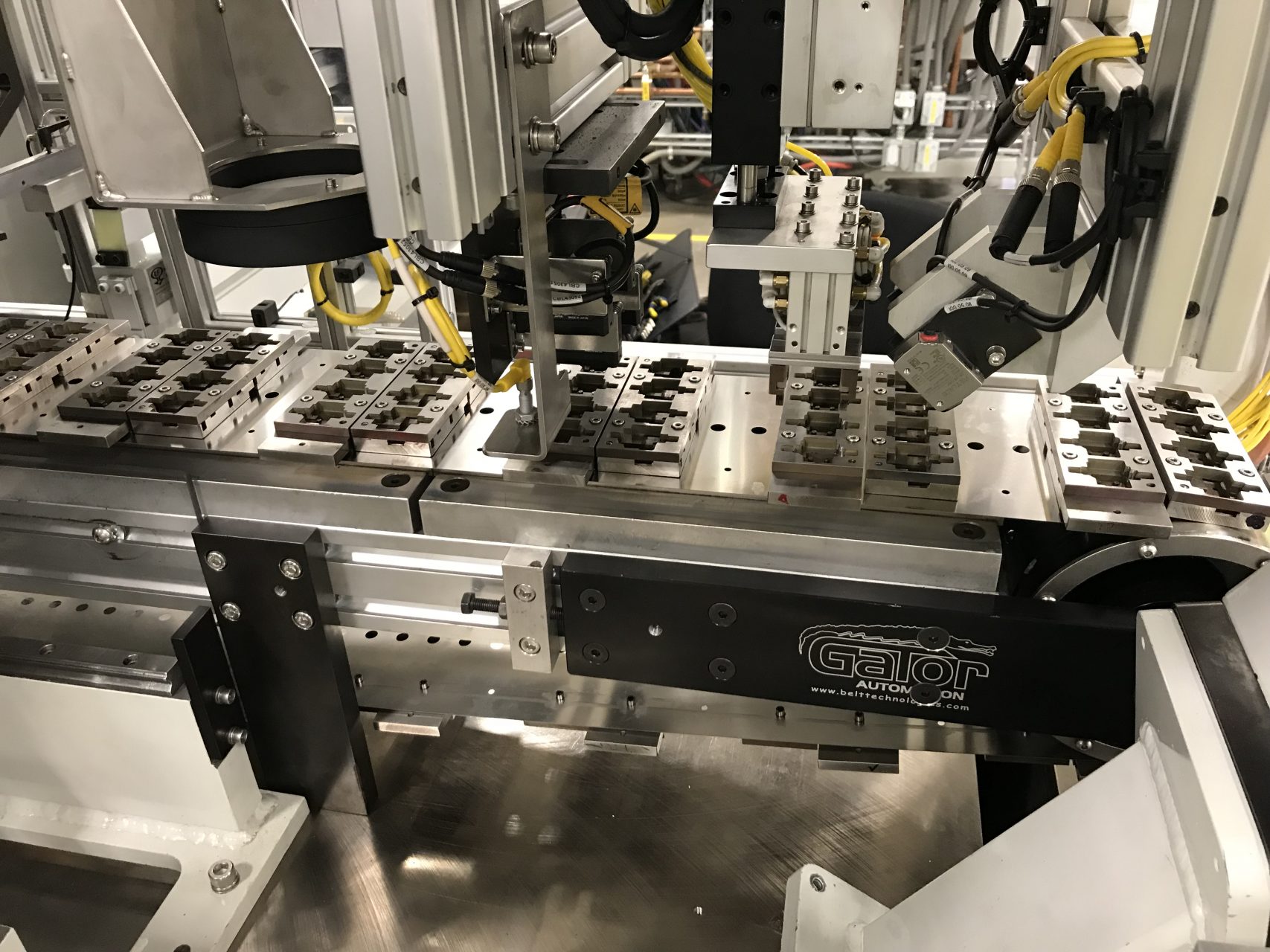 Stainless Steel Conveyor Belt with Custom Product Handling Attachments for Electrical Connector Component Manufacturing